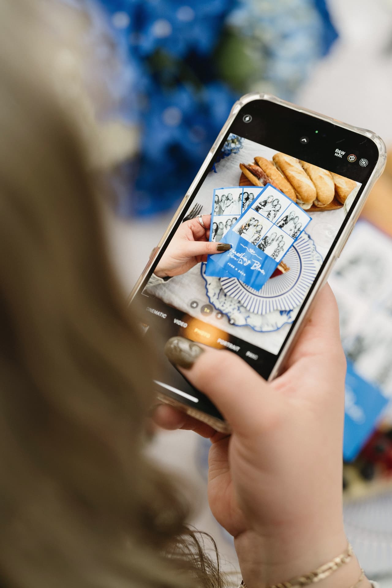 A guest shares a photo of printed photo booth strips at a spring-themed celebration